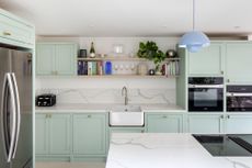 mint green kitchen with island and pendant lighting