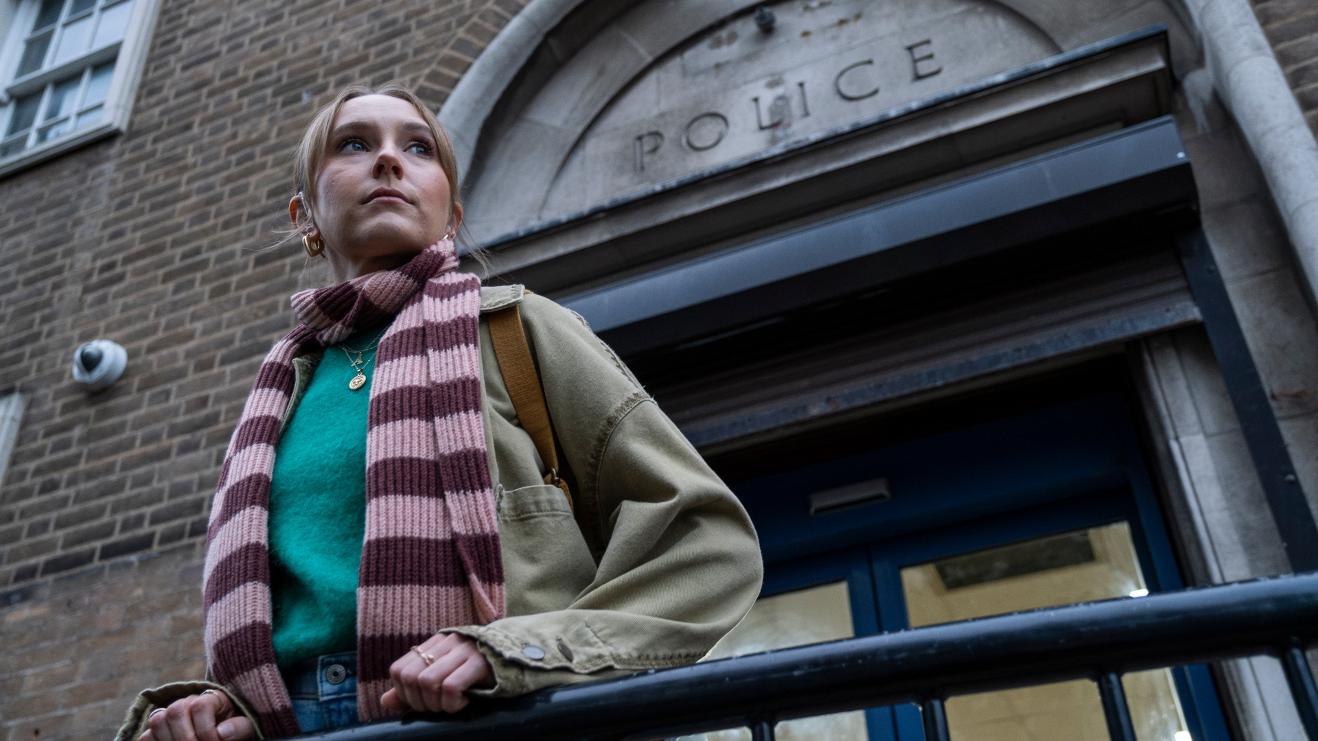 Alison stands outside the police station