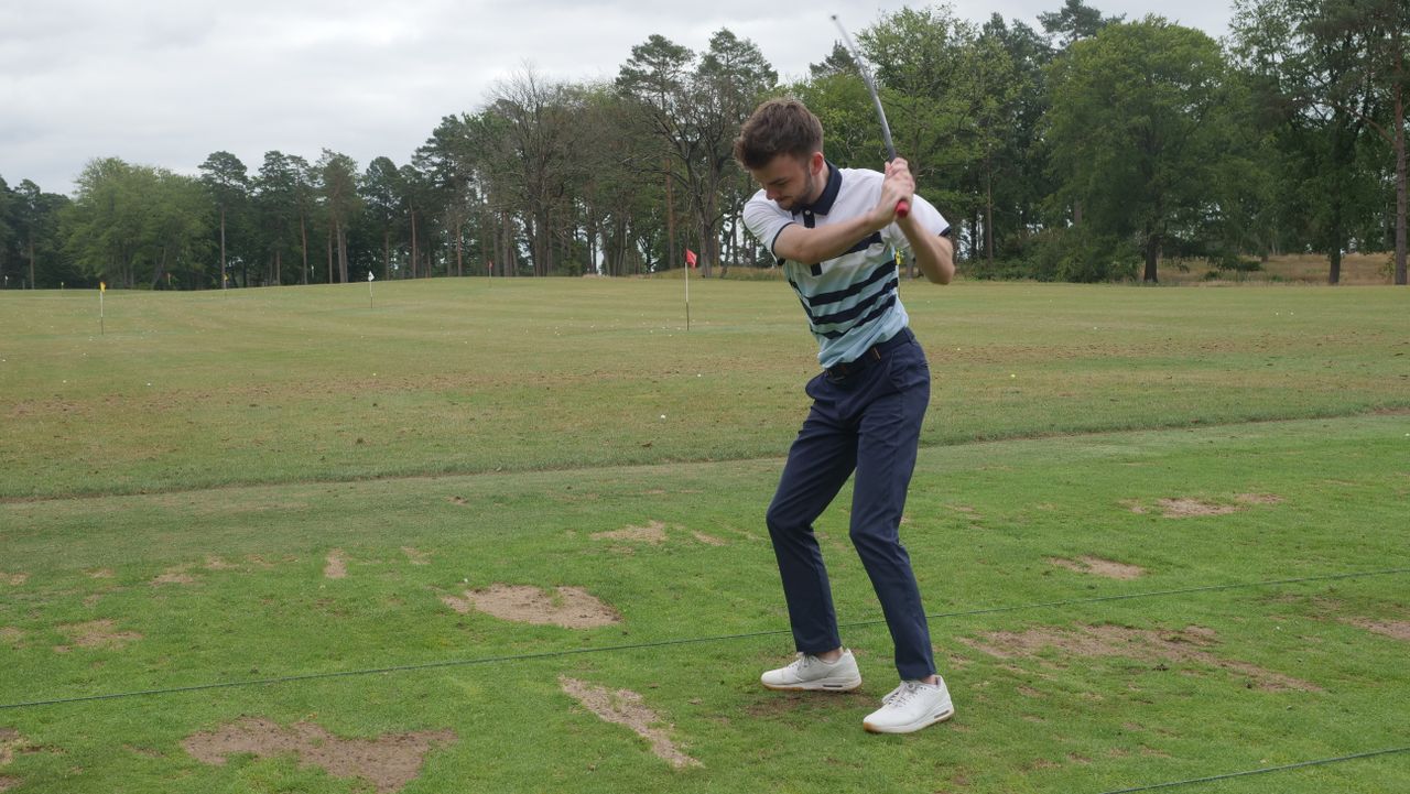 A golfer swinging the SuperSpeed C Club