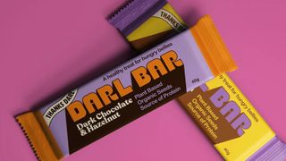 colour trend 2023 example - chocolate bars in brown and orange on a pink background