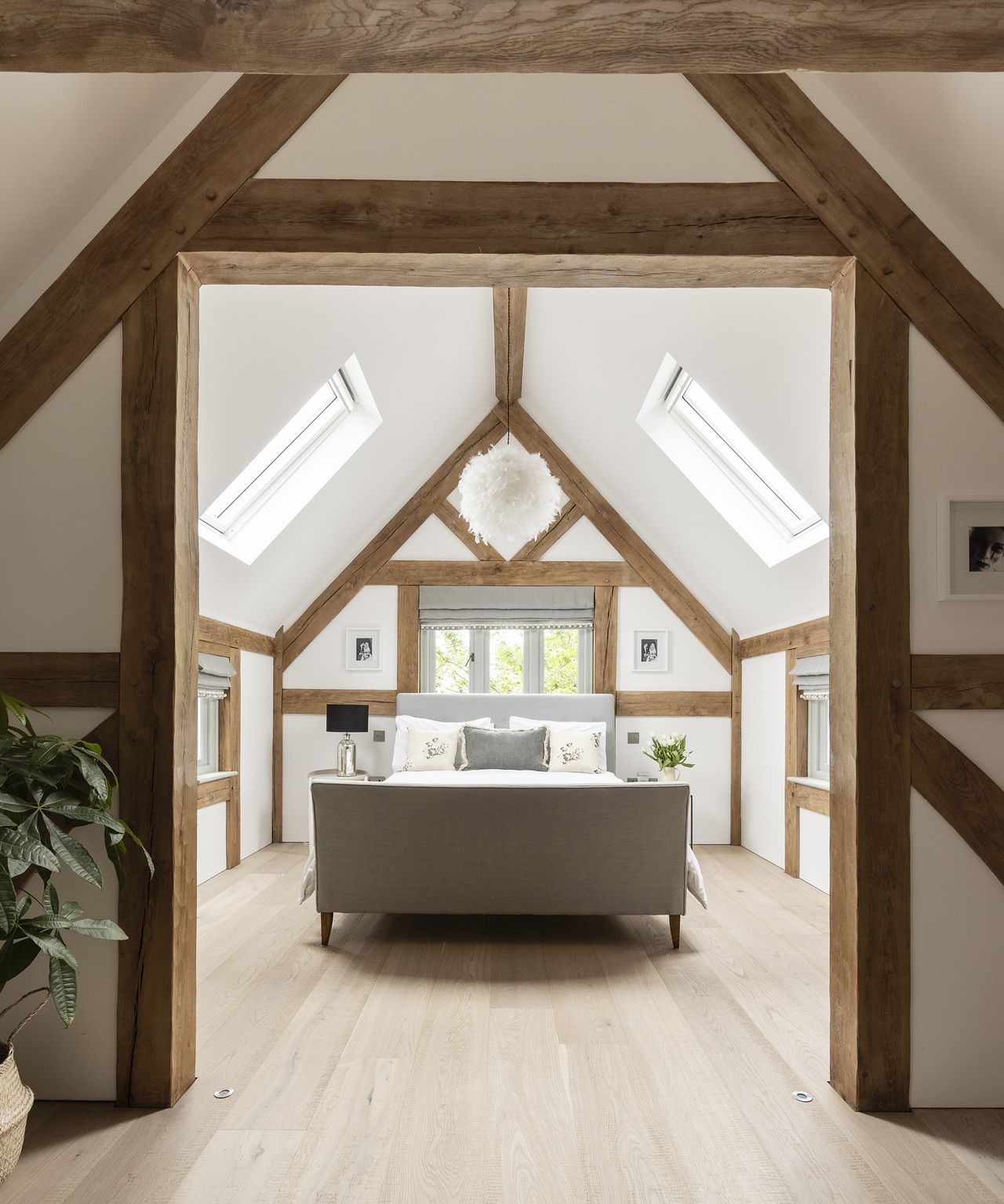 A modern farmhouse style bedroom in the loft of a self build timber frame home