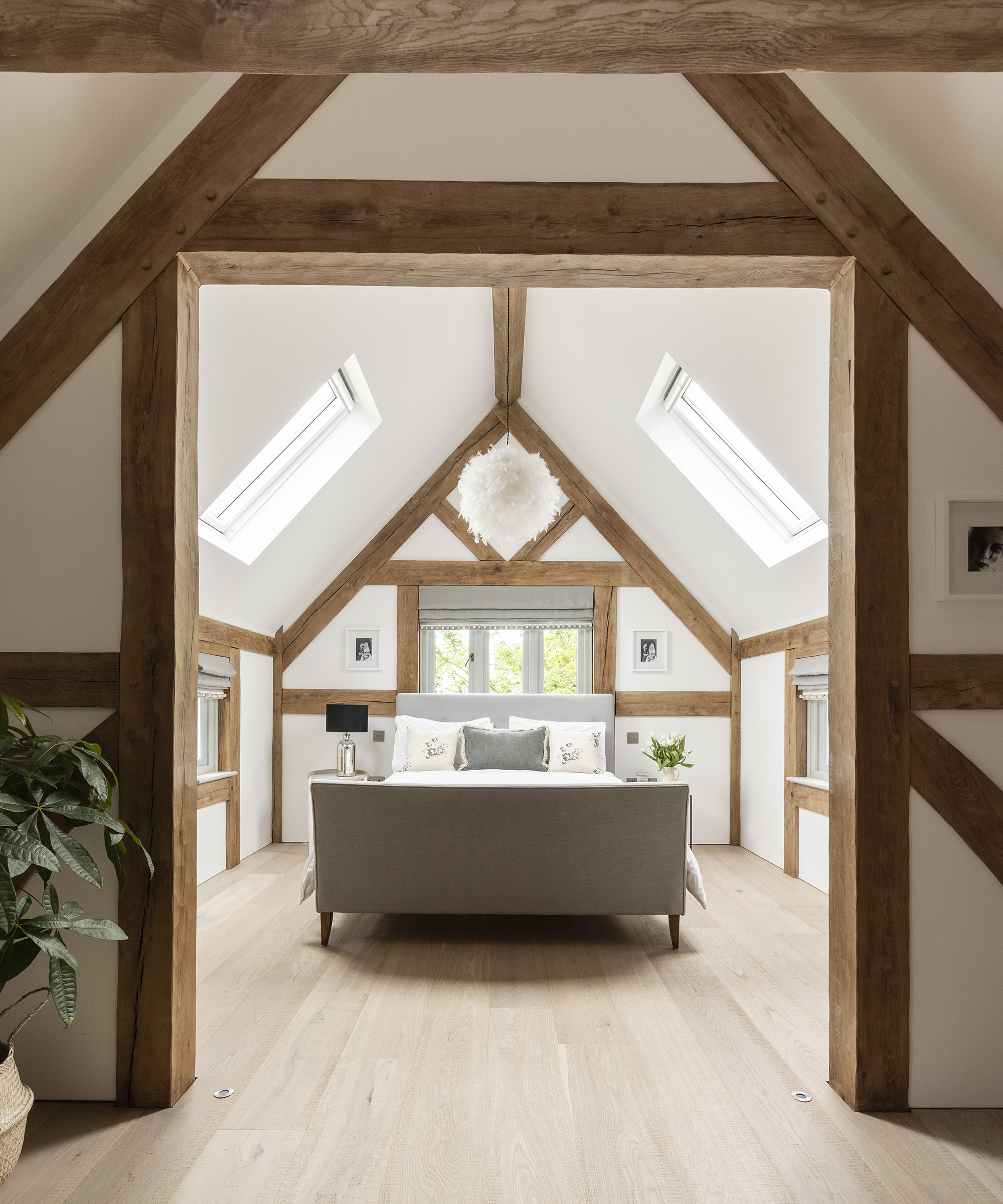 A modern farmhouse style bedroom in the loft of a self build timber frame home