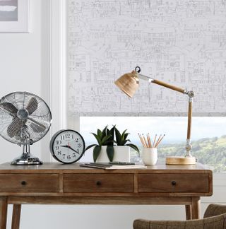 home office with white scheme, wooden desk and intricately patterned subtle blinds by english blinds