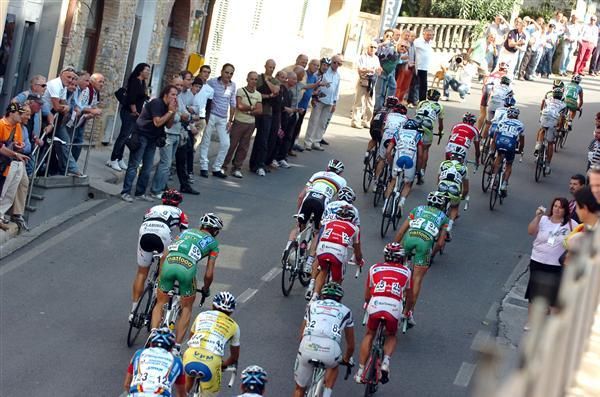 The peloton makes its way through the narrow streets.