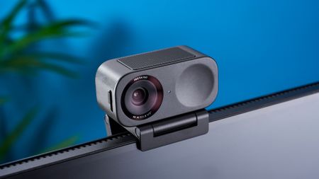 A black Insta360 Link 2C webcam with a magnetic L-shaped mount