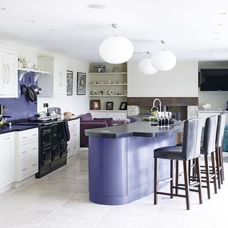 kitchen with white and lavender colour wall and dining area