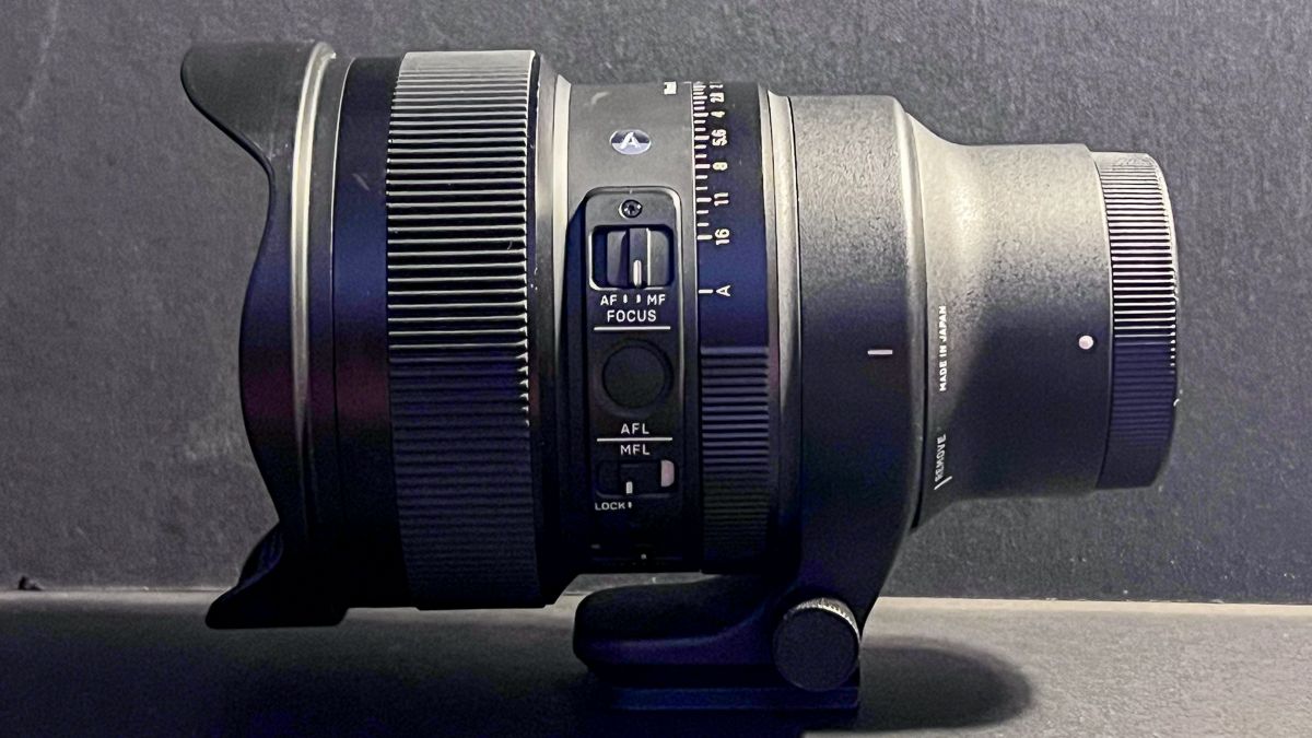 Sigma Art 14mm f/1.4 DG DN lens on a dark surface