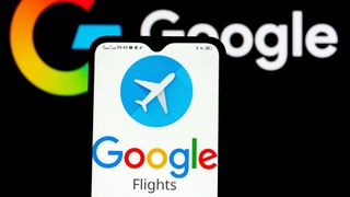 Google Flights logo on phone with Google logo in the background