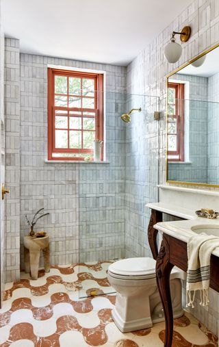 a bathroom with a wavy floor tile and antique vanity