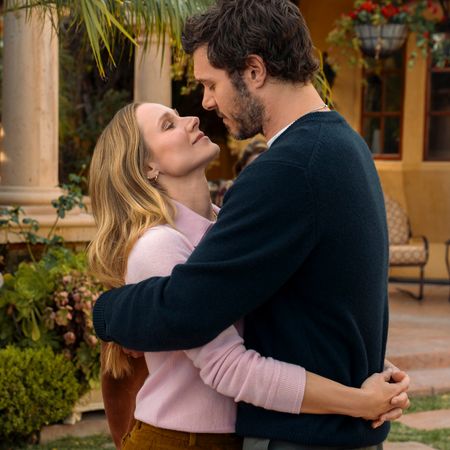 A couple (Kristen Bell as Joanne and Adam Brody as Noah) cuddles while standing in the backyard of a California mansion, in 'Nobody Wants This' season 3.