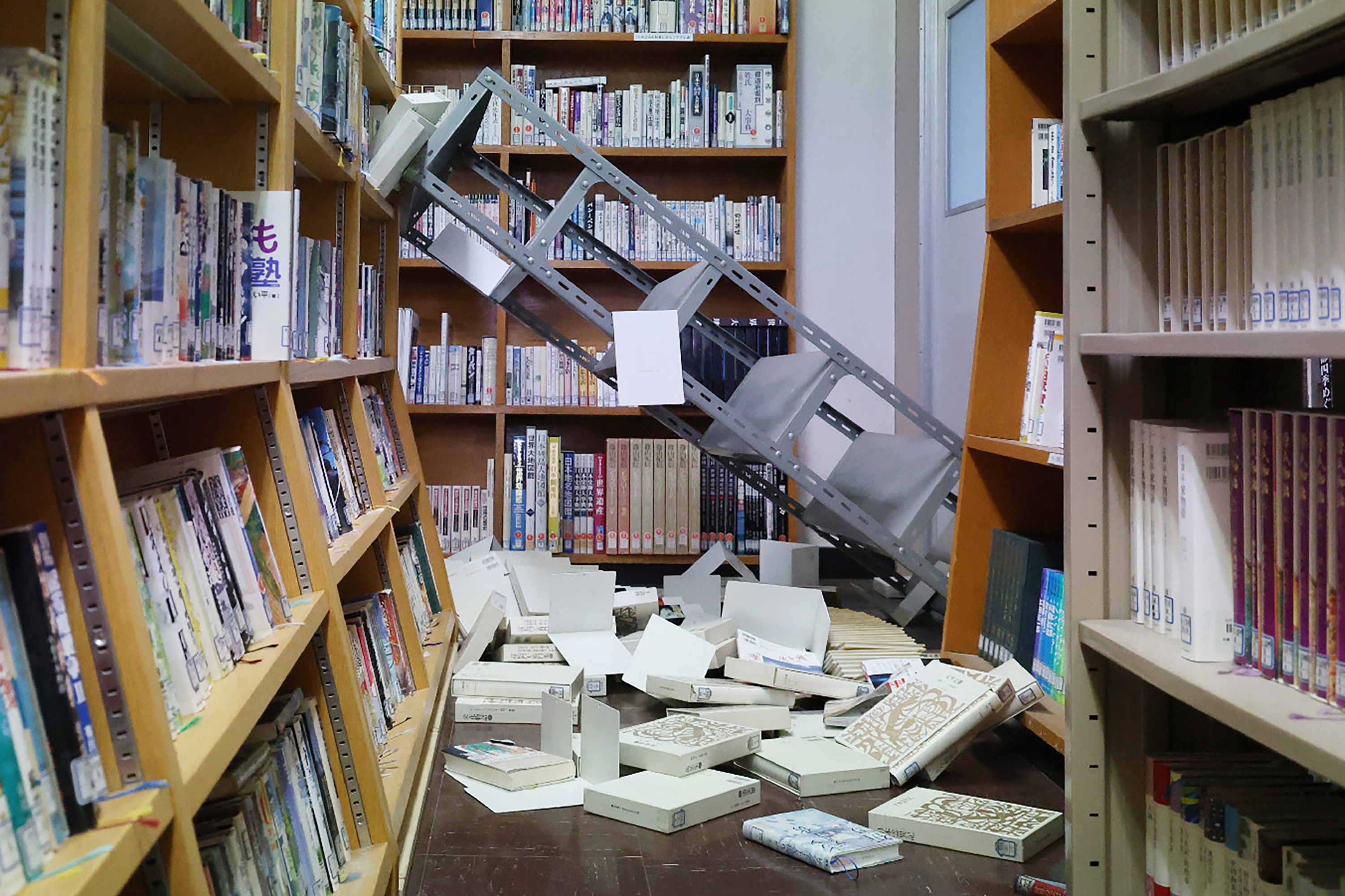A photo of collapse bookshelf in a high school library in Japan on Dec. 9, 2025, following a major earthquake.