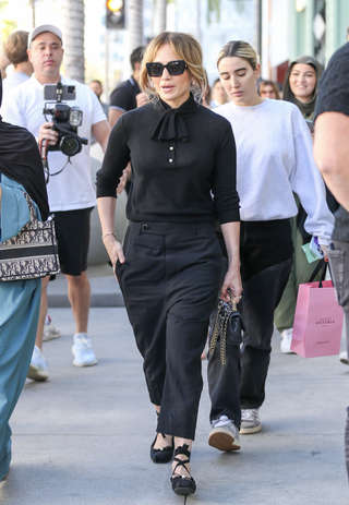 jennifer lopez is seen leaving gucci osteria in beverly hills wearing an all black outfit with ballet flats