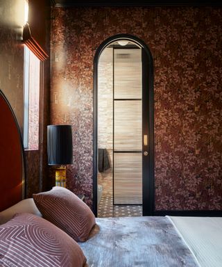 Arched doorway in a bedroom leading to an en suite