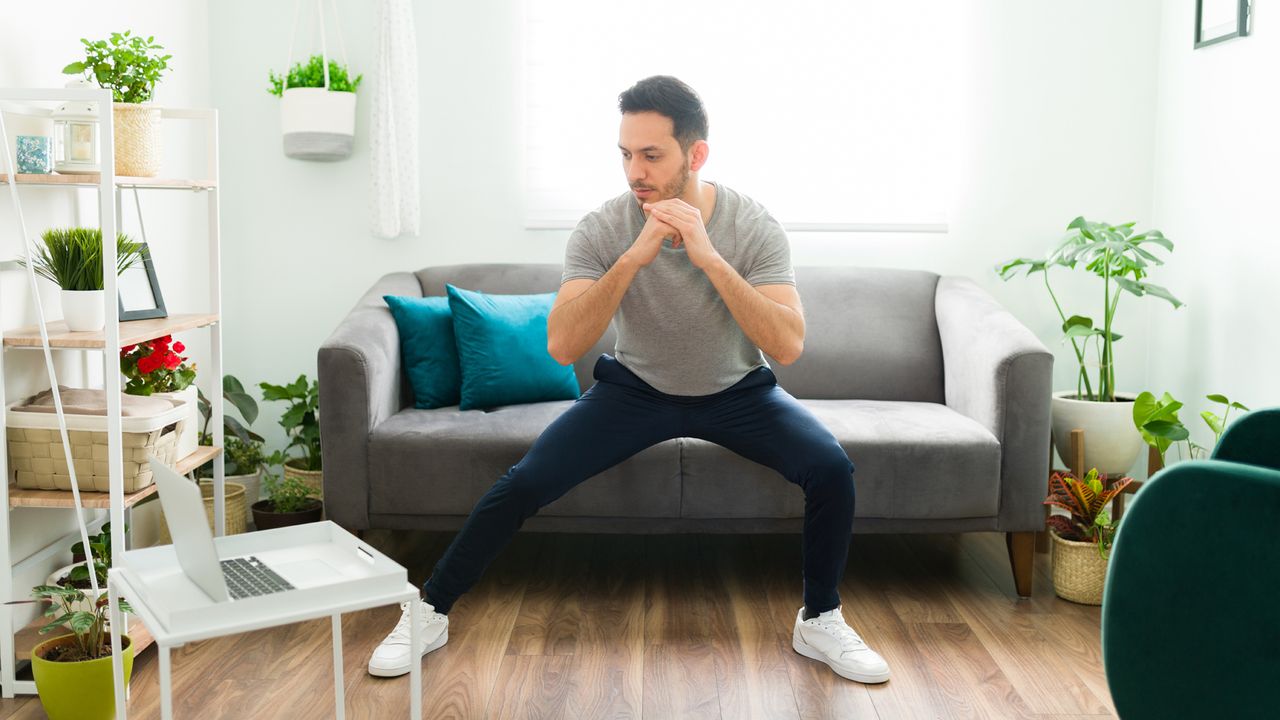 Man completes a HIIT workout at home