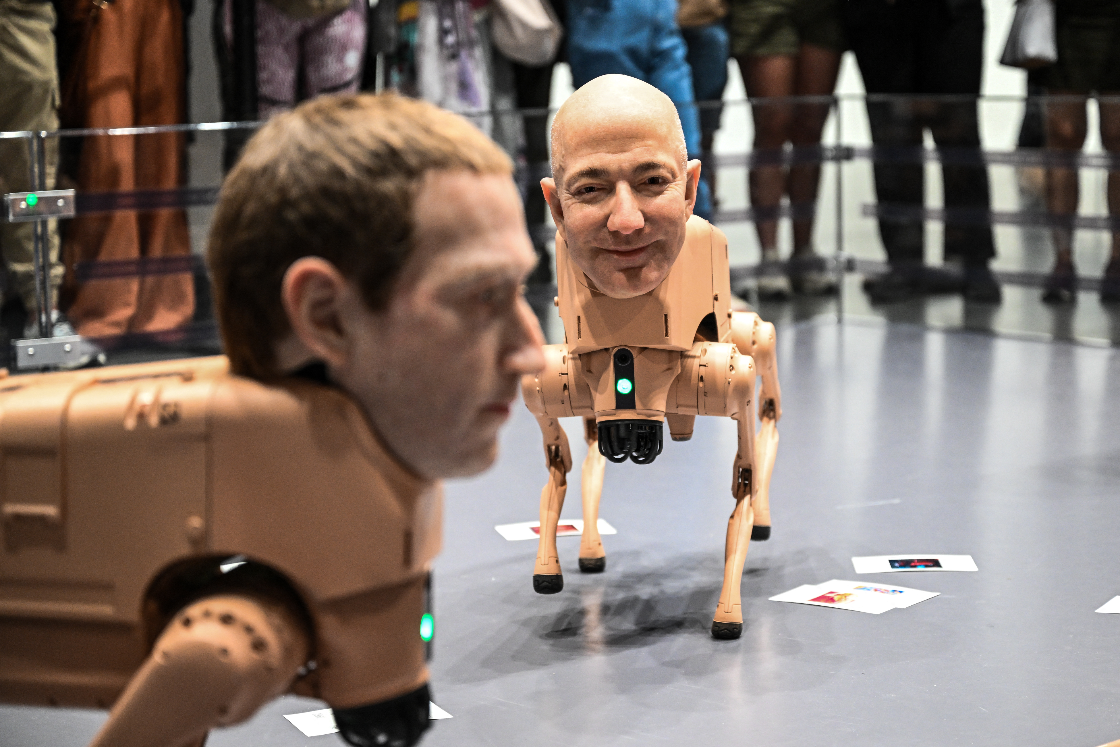Heads of Mark Zuckerberg and Jeff Bezos are seen on robot dogs as a part of an art installation called "Regular Animals" by digital artist Mike Winkelmann, also known as Beeple, during Art Basel 2025 at Miami Beach Convention Center in Miami Beach, Florida, December 7, 2025. (Photo by CHANDAN KHANNA / AFP) / RESTRICTED TO EDITORIAL USE - MANDATORY MENTION OF THE ARTIST UPON PUBLICATION - TO ILLUSTRATE THE EVENT AS SPECIFIED IN THE CAPTION