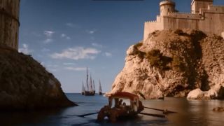 A harbor with a boat leaving the dock in Game of Thrones