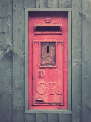 Image of a red Royal Mail postbox encased in fencing, taken on the OM System OM-3 with the Olympus M.Zuiko 12-40mm f/2.8 Pro