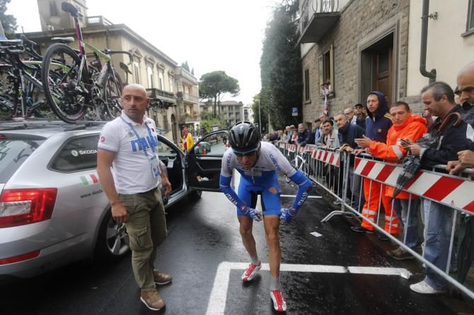 With Paolo Bettini looking on, Italy's Vincenzo Nibali gathers himself after crashing in the elite men's road race world championship