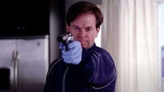 Screenshot of Mark Wahlberg holding a gun at the end of The Departed