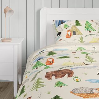 A duvet and pillow set depicting an illustrated woodland scene