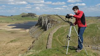 Photographer using a tripod on Hadrian's Wall, UK