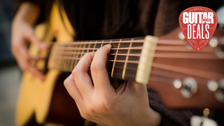 Close up of person playing an acoustic guitar