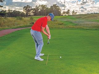 John Howells rehearsing the correct clubface position at halfway through the downswing