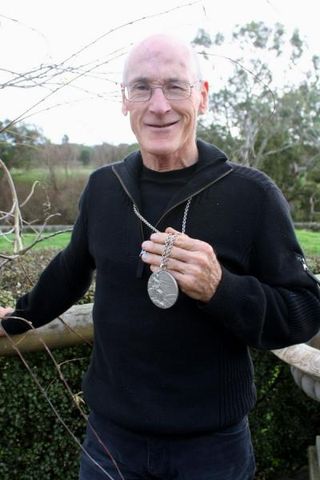 Clyde Sefton with his silver medal at his home in South Purrembete