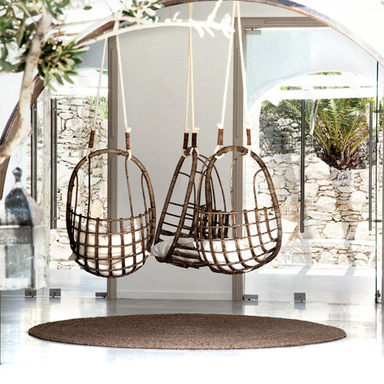 room with hanging chair and glass door