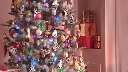 Pink colorful decorated tree with cat, car and more eclectic baubles