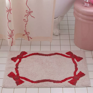 pink and red bath mat with bow design