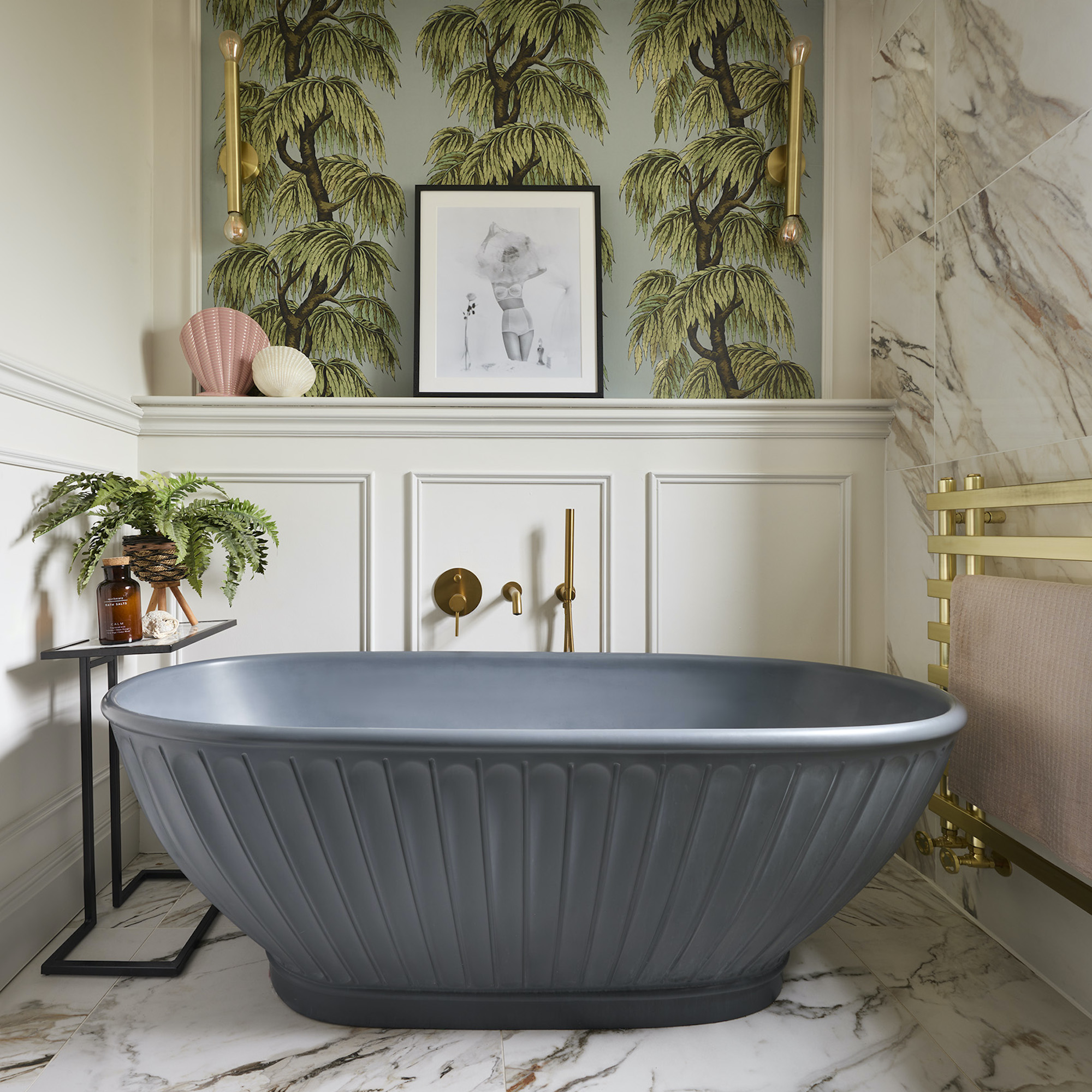 grey bath in panelled bathroom with wallpaper and brass accents