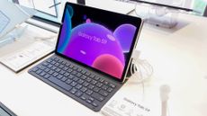 A Galaxy Tab S9 being displayed with a keyboard on a white table