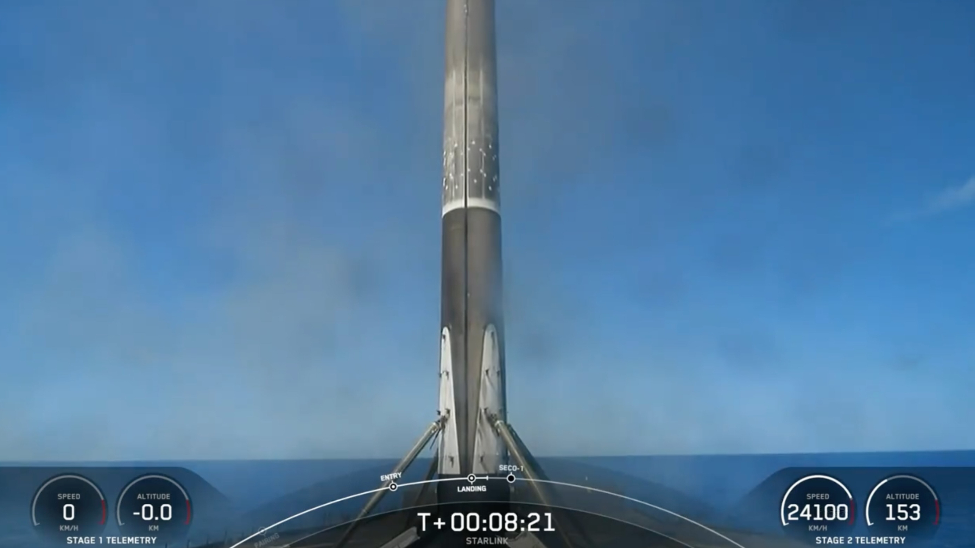 a black and white spacex rocket rests on the deck of a ship at sea
