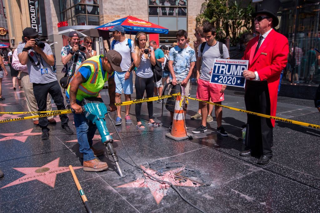 A work crew digs up the vandalized Donald Trump star