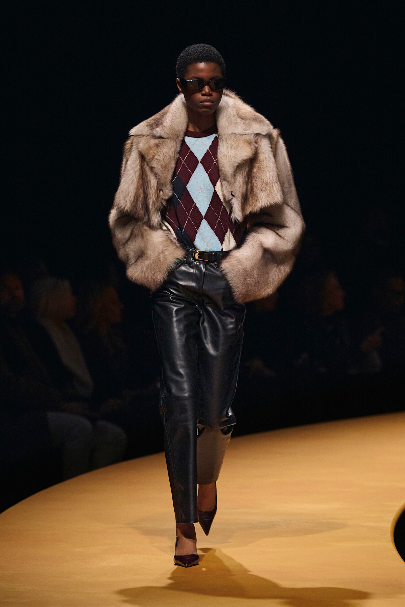 Model on a runway wearing knitwear