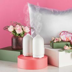 Aldi electric diffusers on display with flowers and pillows