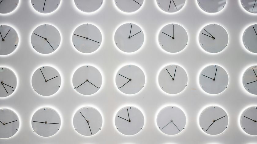 A series of white analog clocks against a gray background, their faces showing various different times.