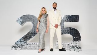 Carol Vorderman and Ashley Banjo stand in front of a sparkly 25 for the Pride of Britain Awards 2024