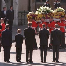 Men carrying Princess Diana's coffin with Prince Harry, Prince William, King Charles, Earl Spencer and Prince Philip facing it with their backs to the camera
