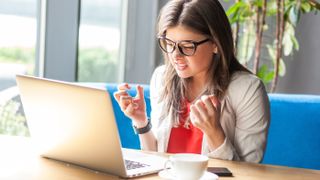 Angry woman using a laptop