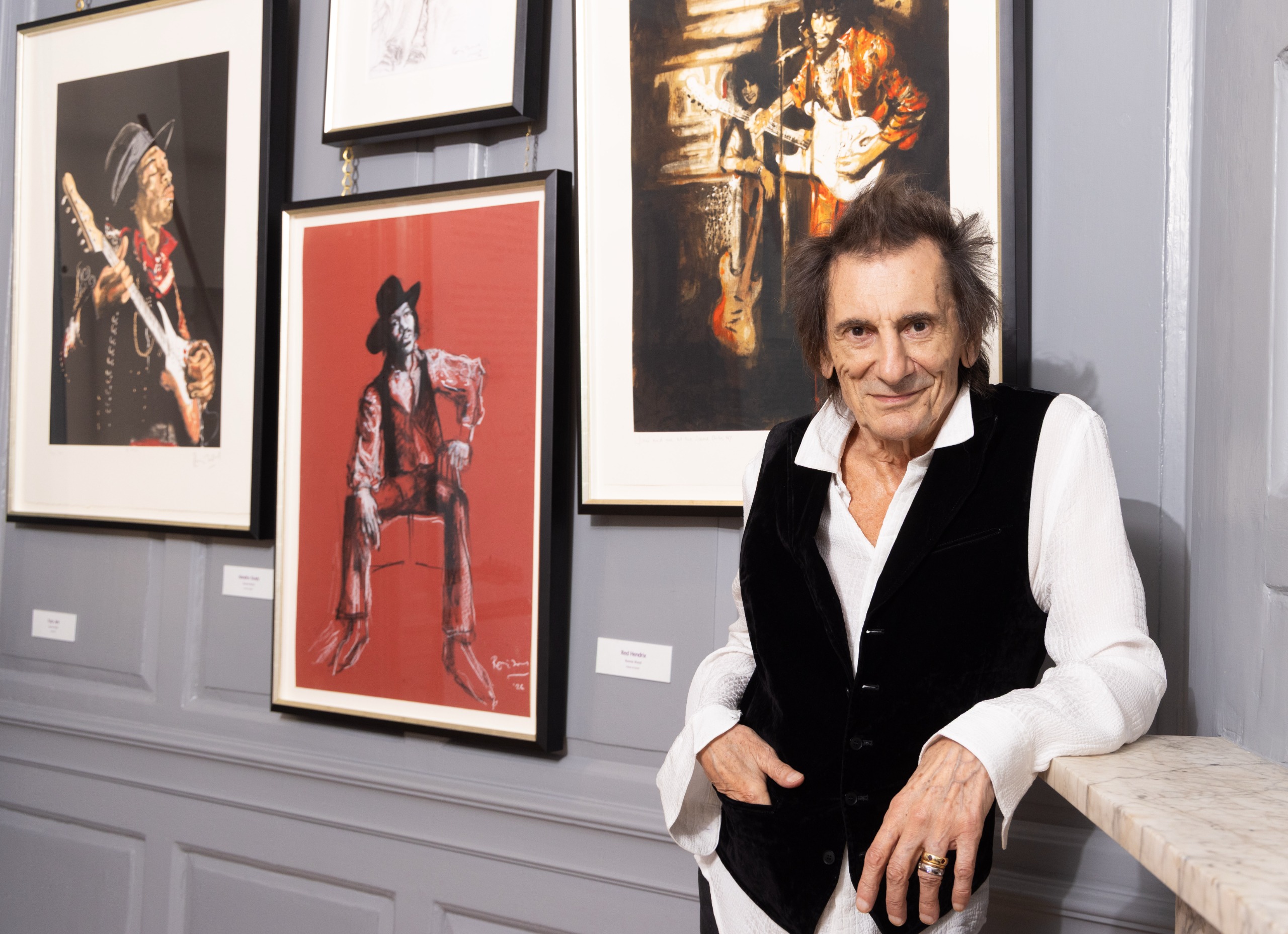 Ronnie Wood photographed in front of one of his pictures of Jimi Hendrix