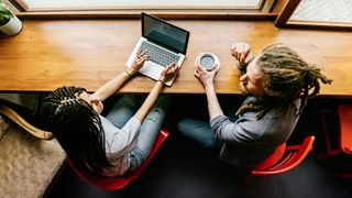 Two people working in coffee shop