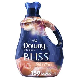 A dark blue plastic bottle of Downy Infusions Liquid Laundry Fabric Softener, Bliss, Sparkling Amber & Rose Scent