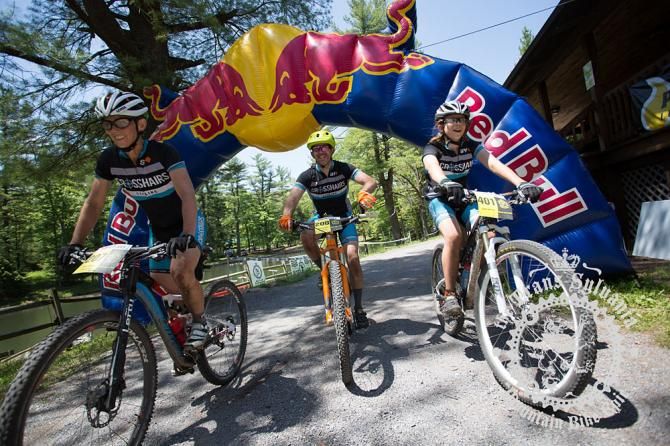 Libbey Sheldon, Chris Merriam, and Jonah Merriam cross the finish line together.