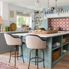 Kitchen with open shelving and island with storage and two bar stools