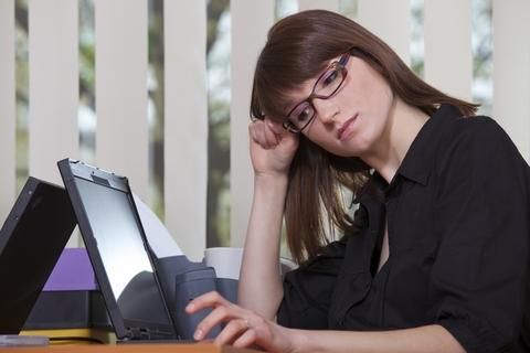 Woman at computer, unhappy