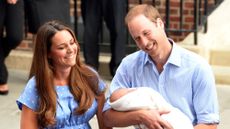 Catherine, Princess of Wales and Prince William, who is holding their newborn son Prince George, depart the Lindo Wing of St Mary's Hospital on July 23, 2013