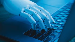 A robot's hand typing on a laptop keyboard