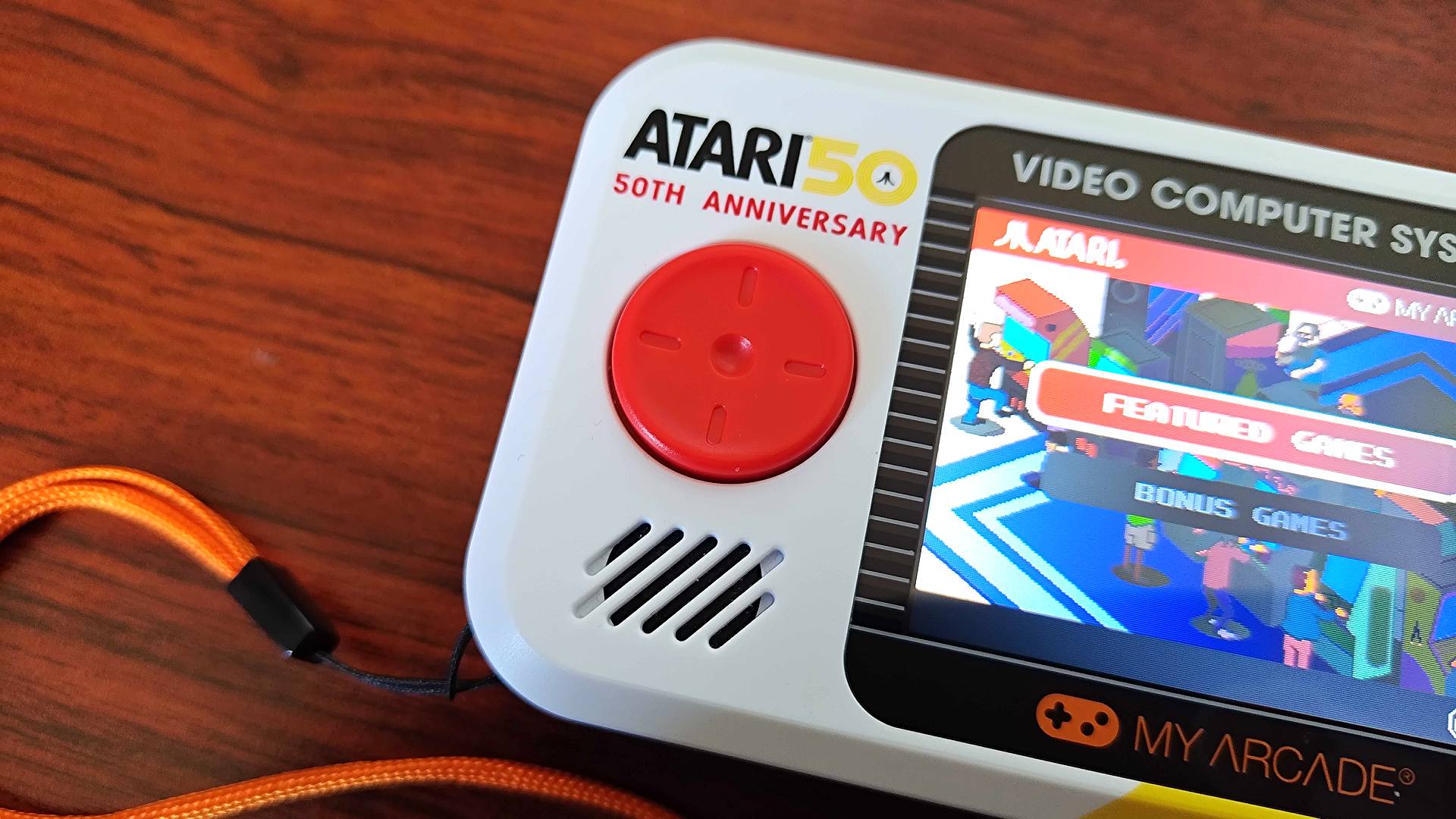 Close up of Atari Pocket Player Pro handheld red disc d-pad.